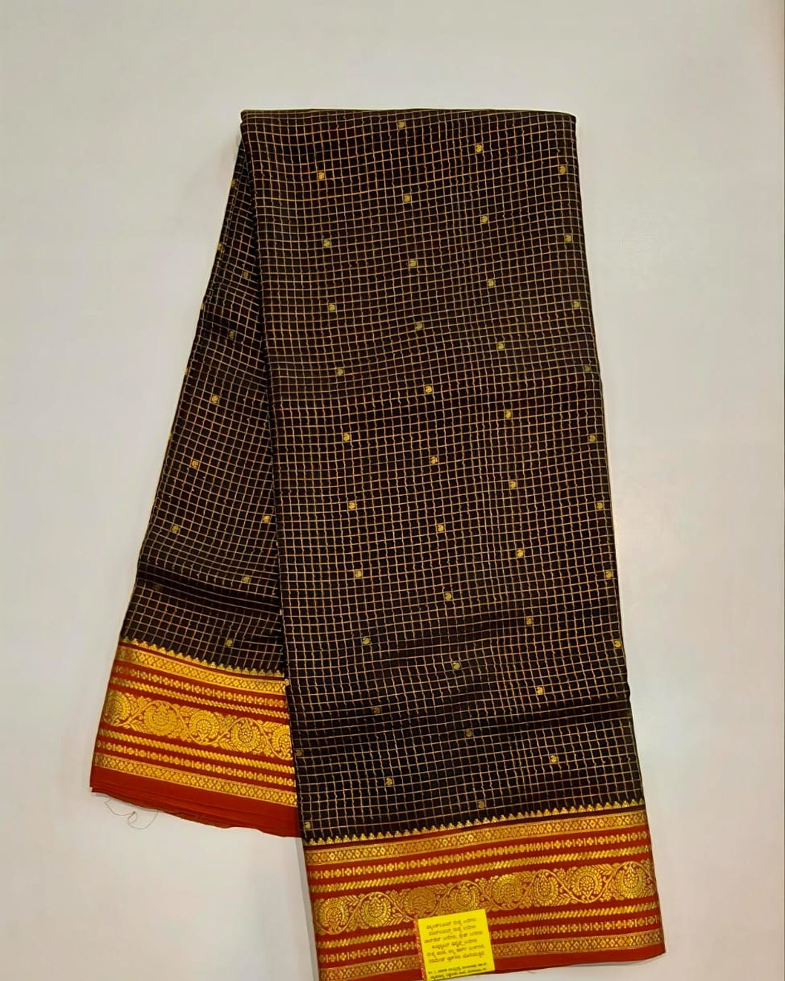 Black pure Mysore silk crape saree with gold checks and red gold zari border